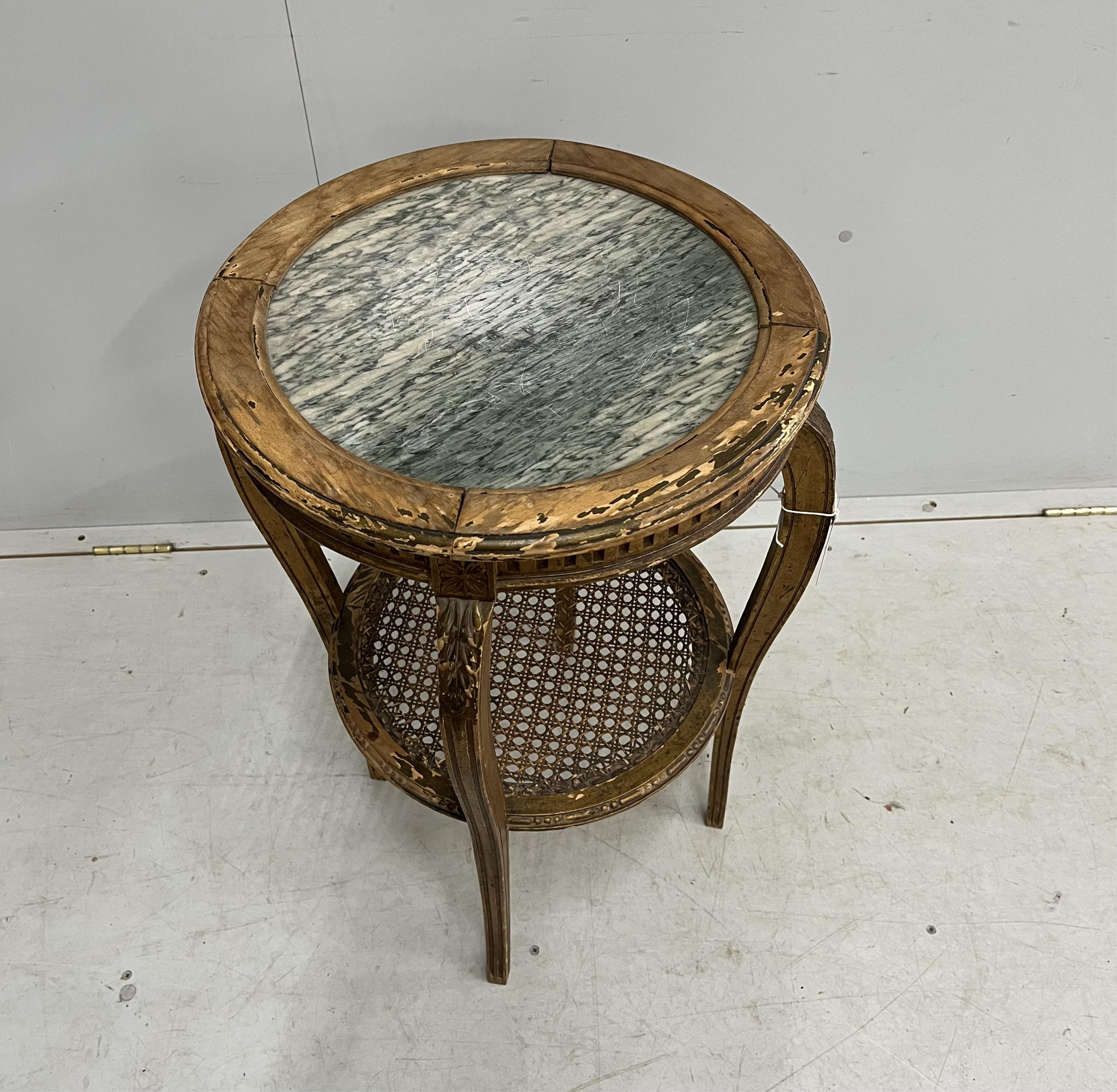 A late 19th century French circular marble topped giltwood two tier table with caned undertier, diameter 46cm, height 75cm. Condition - poor to fair